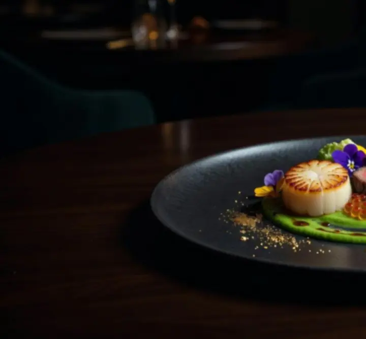 Luxurious chef special dish plated in a cinematic Crown-style dining setting