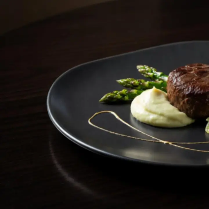 Gourmet signature dish plated with modern artistic presentation at Gambit Crown Dining.